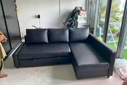 Right-hand black faux leather L-shaped sofa with storage - good condition