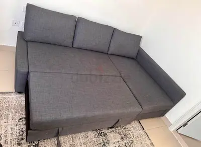Compact grey L-shaped sofa bed with storage - excellent condition