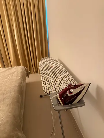 Selling a Tefal iron and ironing board together for AED 100