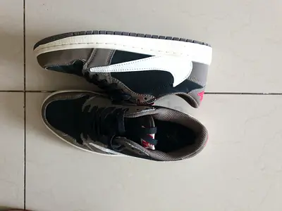 Used low-top black and grey sneakers with white swoosh - size unknown
