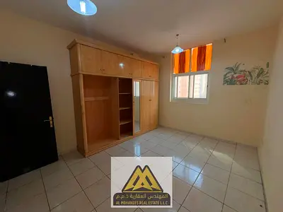 2BR in Al Nuaimiya 2, Ajman, balcony, 2 baths, central AC. AED 34K yearly, payable in 4 installments.