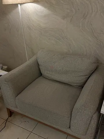 Grey Armchair with Slipcover and Two Yellow Cushions
