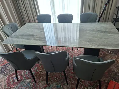 Marble-top dining table with 8grey upholstered chairs
