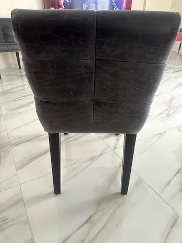 Grey upholstered dining chair with wooden legs - good condition from Marina home