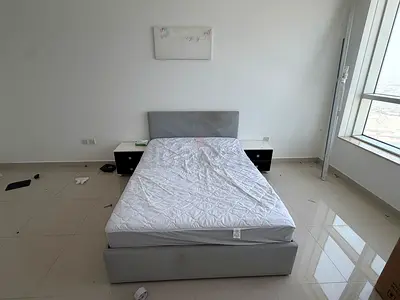 Gray upholstered bed frame with mattress and 1 x bedside tables - good condition