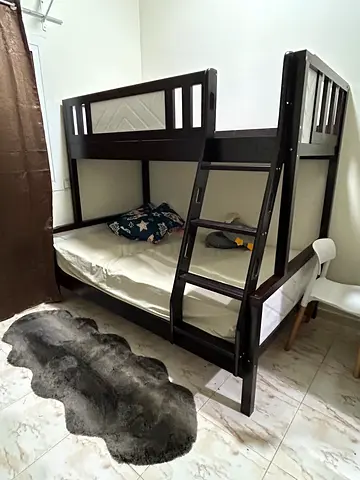 Dark wood bunk bed with safety rails — good condition