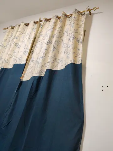 Pair of blue and cream patterned blackout curtains, ready to hang