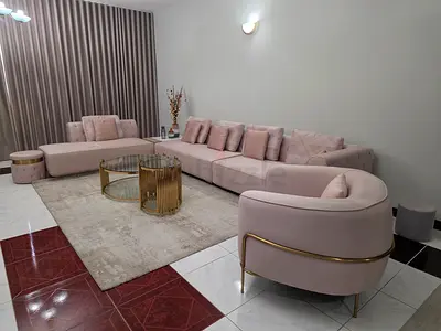 Light pink sectional sofa with matching armchair - good condition