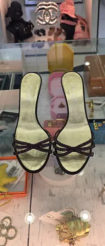 Pair of women's slip-on sandals with braided straps, size unknown