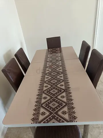 6-seater dining table with patterned glass top and brown chairs