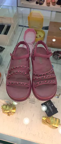 Pink platform sandals with chain-detail straps, size unknown