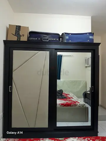 3 door Dark wood wardrobe with mirrored sliding doors and padded panel — good condition