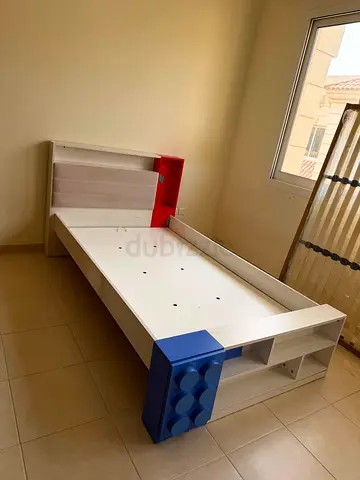 Single kids bed frame with built-in storage (white with blue & red accents)