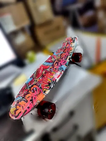 Used colorful cruiser skateboard / penny board with graffiti deck and LED wheels