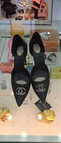Black pointed-toe slingback heels with crystal embellishments - size not specified
