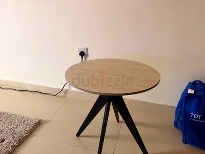 Round wooden side table with tripod metal legs