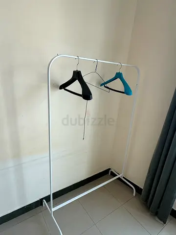 IKEA PELLO-style single garment rack with two plastic coat hangers