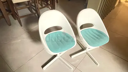 Pair of modern kids white swivel chairs with teal cushions