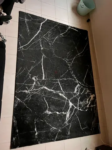 Black marble-pattern area rug - good condition