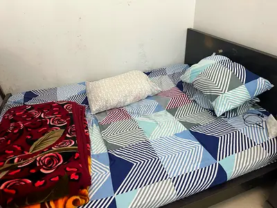 Queen wooden bed frame with mattress and bedding - good condition
