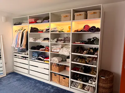IKEA PAX-style built-in wardrobe system with drawers and shelving, white