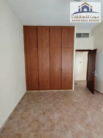 3-bedroom apartment with a large living room for rent in Al Majaz 3; features a spacious balcony and built-in wardrobes. Prime location. Rent: AED 32,