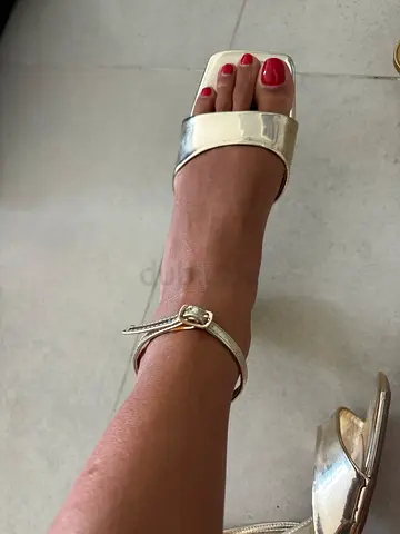 Gold open-toe ankle-strap women's heels, size not specified