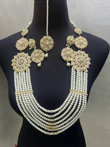 Traditional multi-strand pearl necklace with gold-tone floral motifs