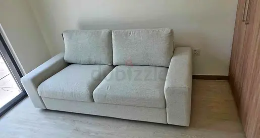 Comfortable light beige 2-seater sofa bed