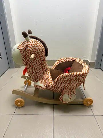 Rocking giraffe toy with wheels and harness