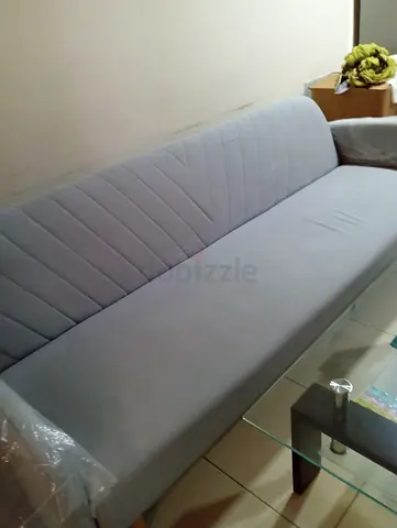 Grey fabric sofa bed with V-patterned backrest Sofa cum bed