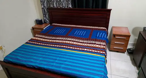 King Size wooden bed frame with two bedside cabinets and new mattress - good condition