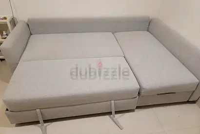 Light grey fabric corner sofa bed with storage compartment