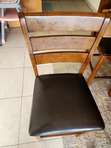 A 6 seater dining set with 4 Wooden Dining Chairs with Brown Faux Leather Seats and a 3 seater bench