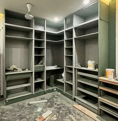 Custom built-in walk-in closet shelving units (unfinished)
