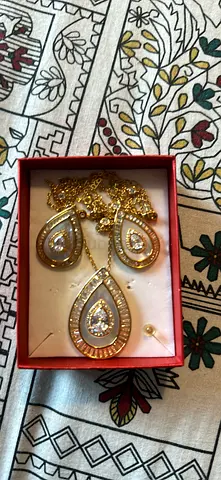 Gold-tone teardrop pendant and earrings set with cubic zirconia