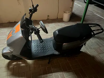 Used electric scooter with rear rack — good condition