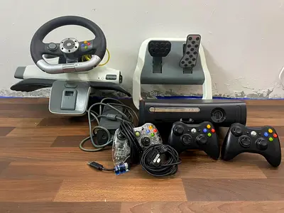 Xbox 360 console bundle with steering wheel, pedals and 3 controllers cracked with built in games