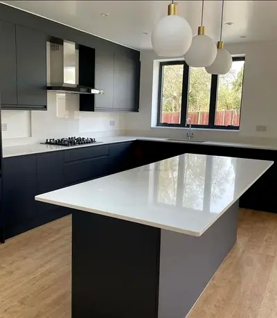 Modern black kitchen with large white island