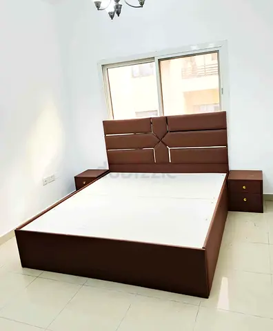 Brown upholstered king bed frame with matching bedside tables