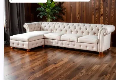 Cream tufted L-shaped Chesterfield sofa with chaise — good condition