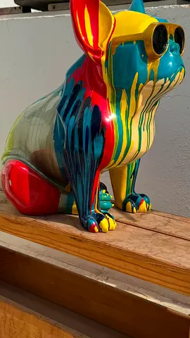 A colorful bulldog statue painted using the drip glazing technique.