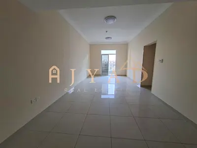 Annual rent: 2BR Al Jurf 3, 2 baths, central AC, balcony, built-in wardrobes, flexible payments, premium finish, prime location.