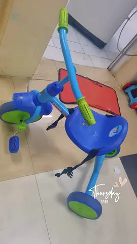 Used blue toddler tricycle with push handle and safety straps