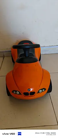 Kids ride-on BMW push car — orange, good condition