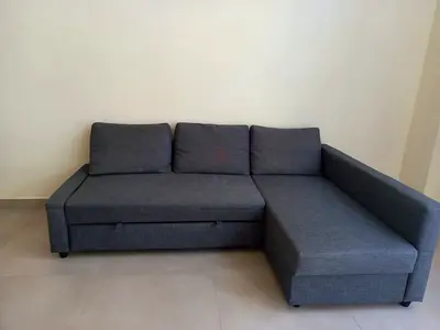 Grey L-shaped fabric sofa with storage, good condition