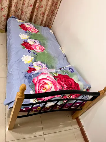 Single metal & wood bed frame with floral mattress topper