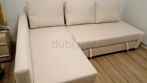 Light beige L-shaped sofa bed with storage — good condition