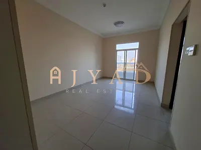 Annual rent: 1BR Al Jurf 3, master, built-in wardrobes, central AC, sunny balcony, flexible payments, prime location, easy Dubai exit.