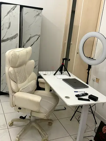 Cream leather swivel office chair with high back and armrests